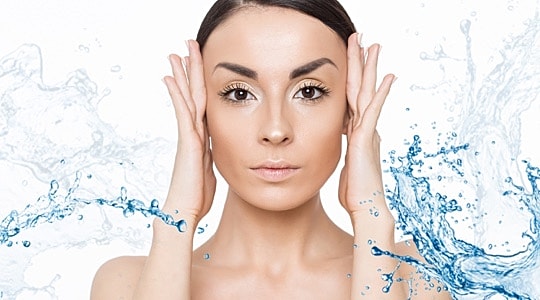 Woman with water splashes on clear background.