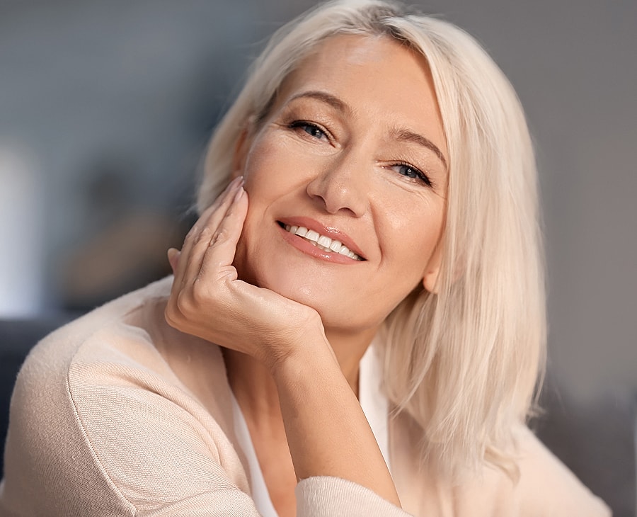 Smiling woman with blonde hair and soft lighting