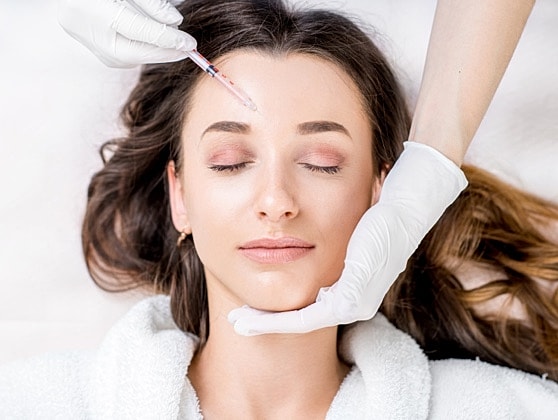 Woman receiving a cosmetic injection treatment.