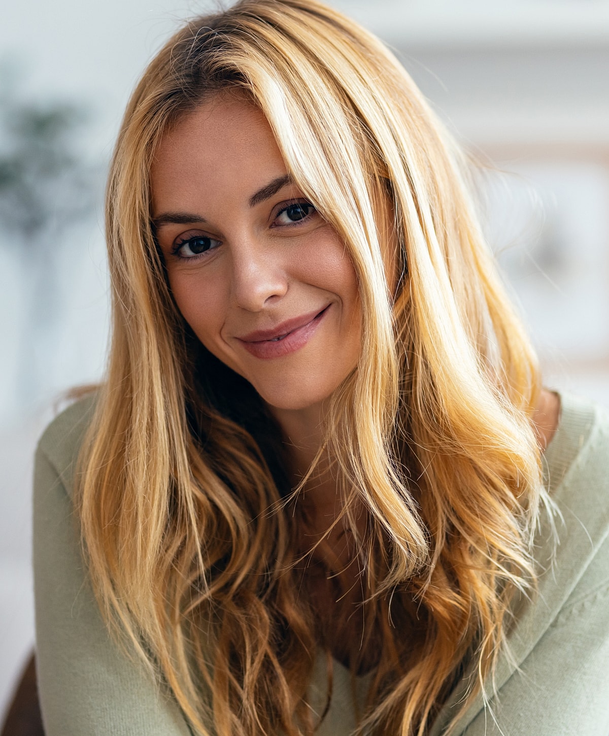 Model with wavy hair in black outfit.