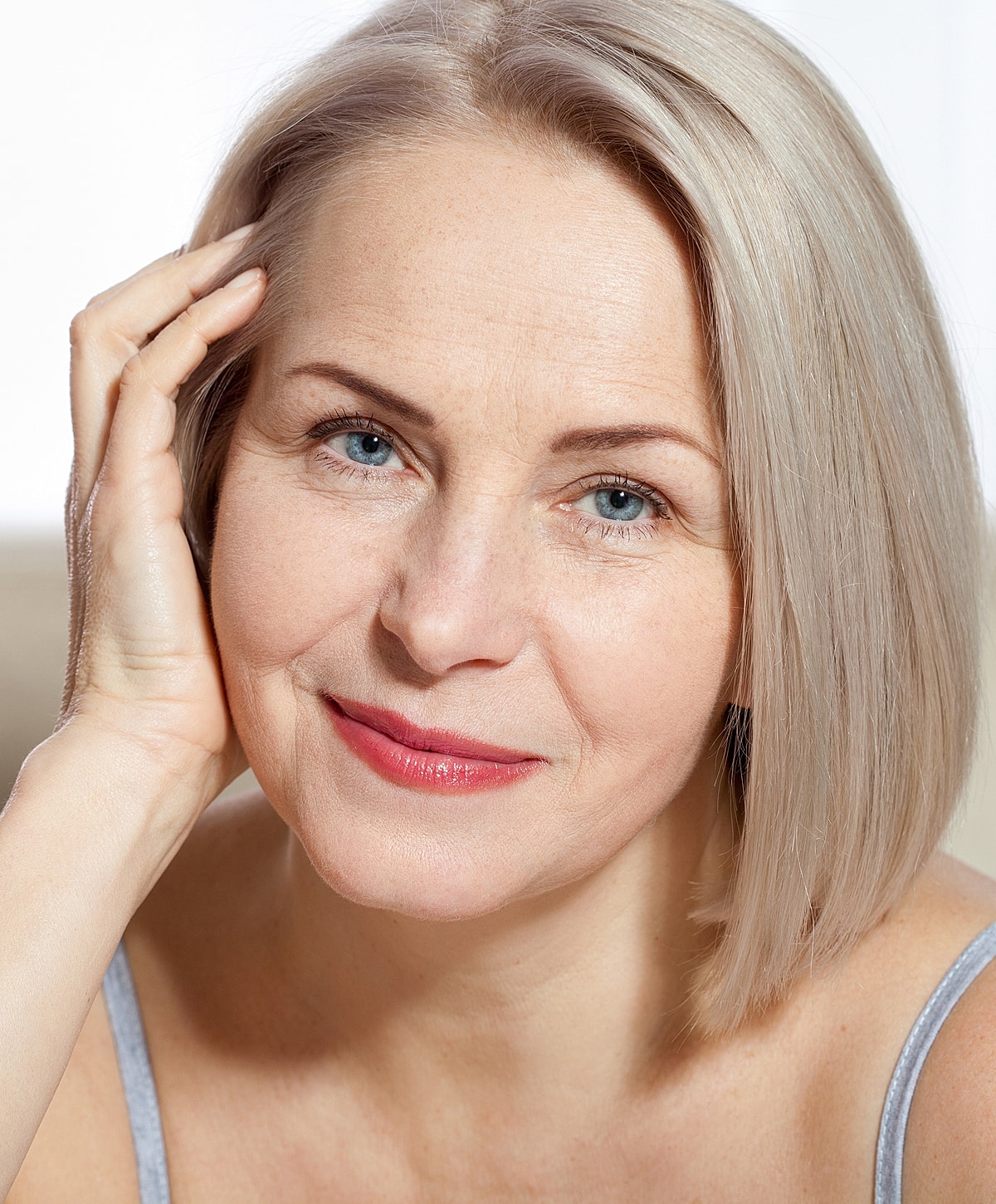 Roswell Sculptra model with short blonde hair, natural light.