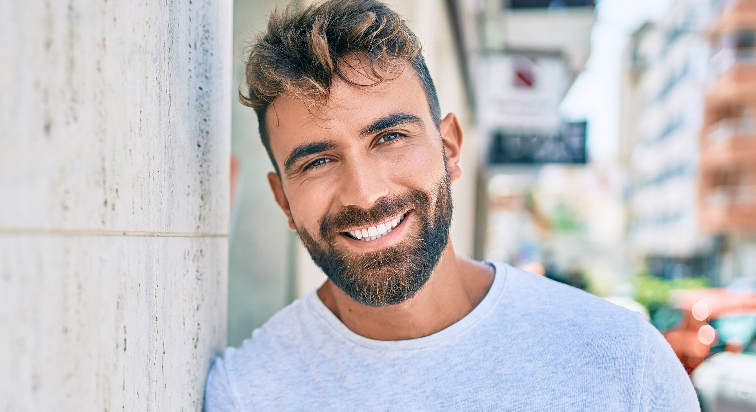 Roswell Men's services model leaning against a wall outdoors.