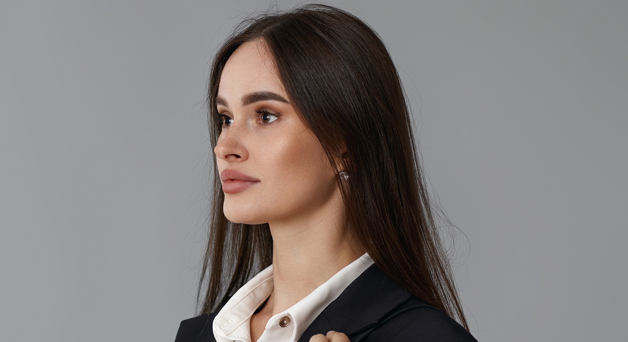 Roswell Acne Scar Removal model with long hair in profile.