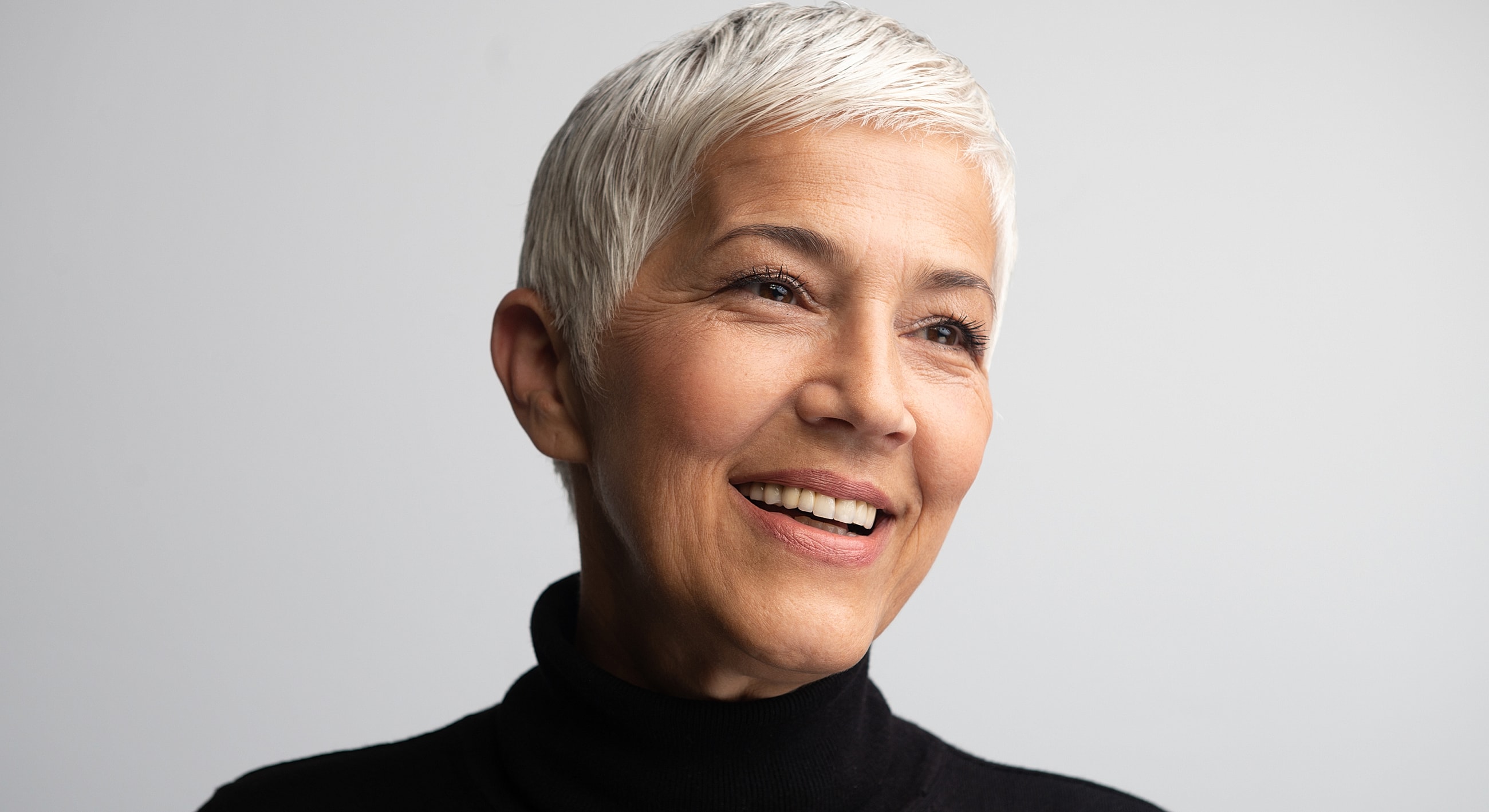 Roswell Anti-Aging Facial model with short gray hair.