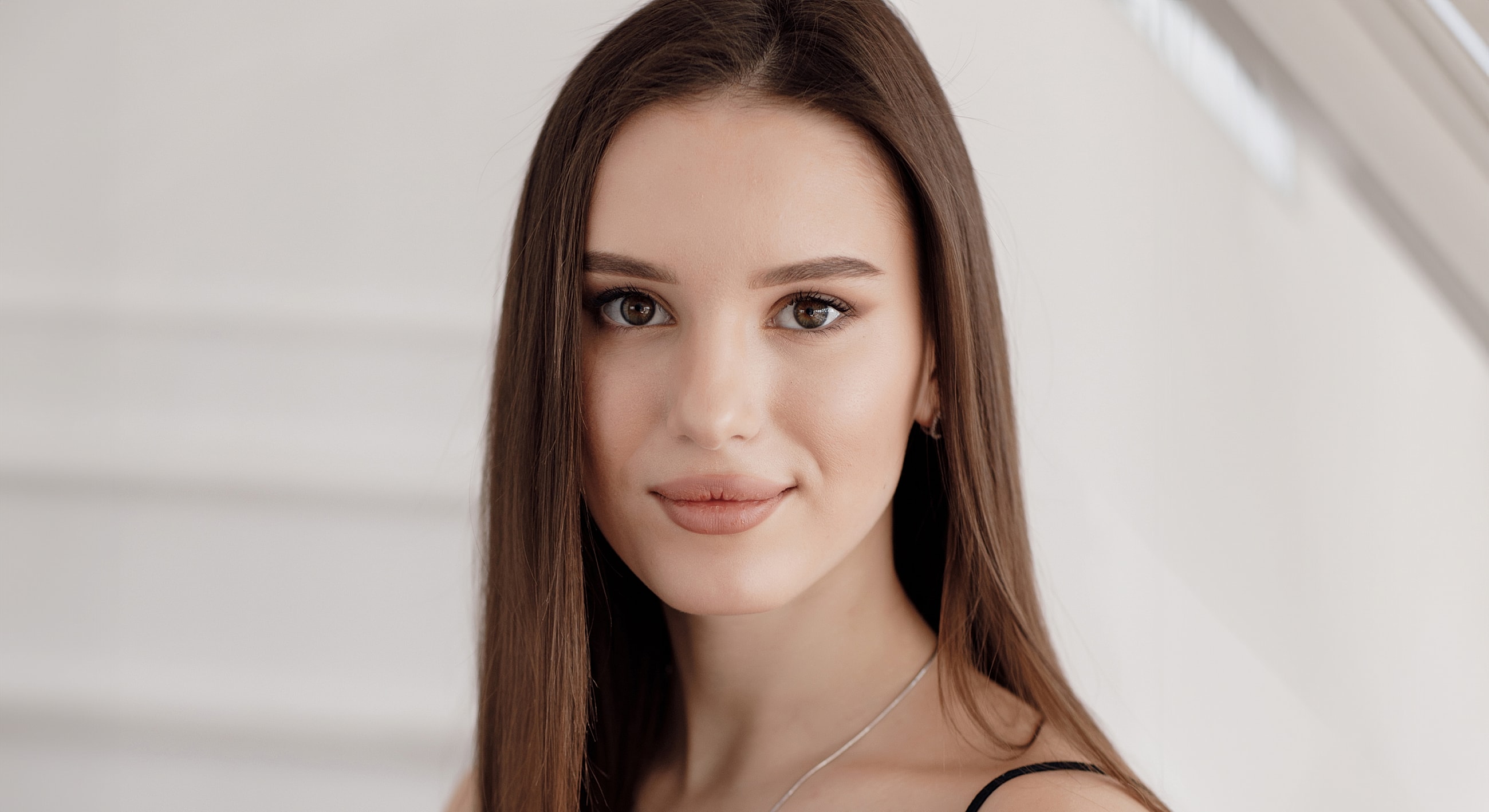 Roswell Acne Facial model with long hair, neutral expression.
