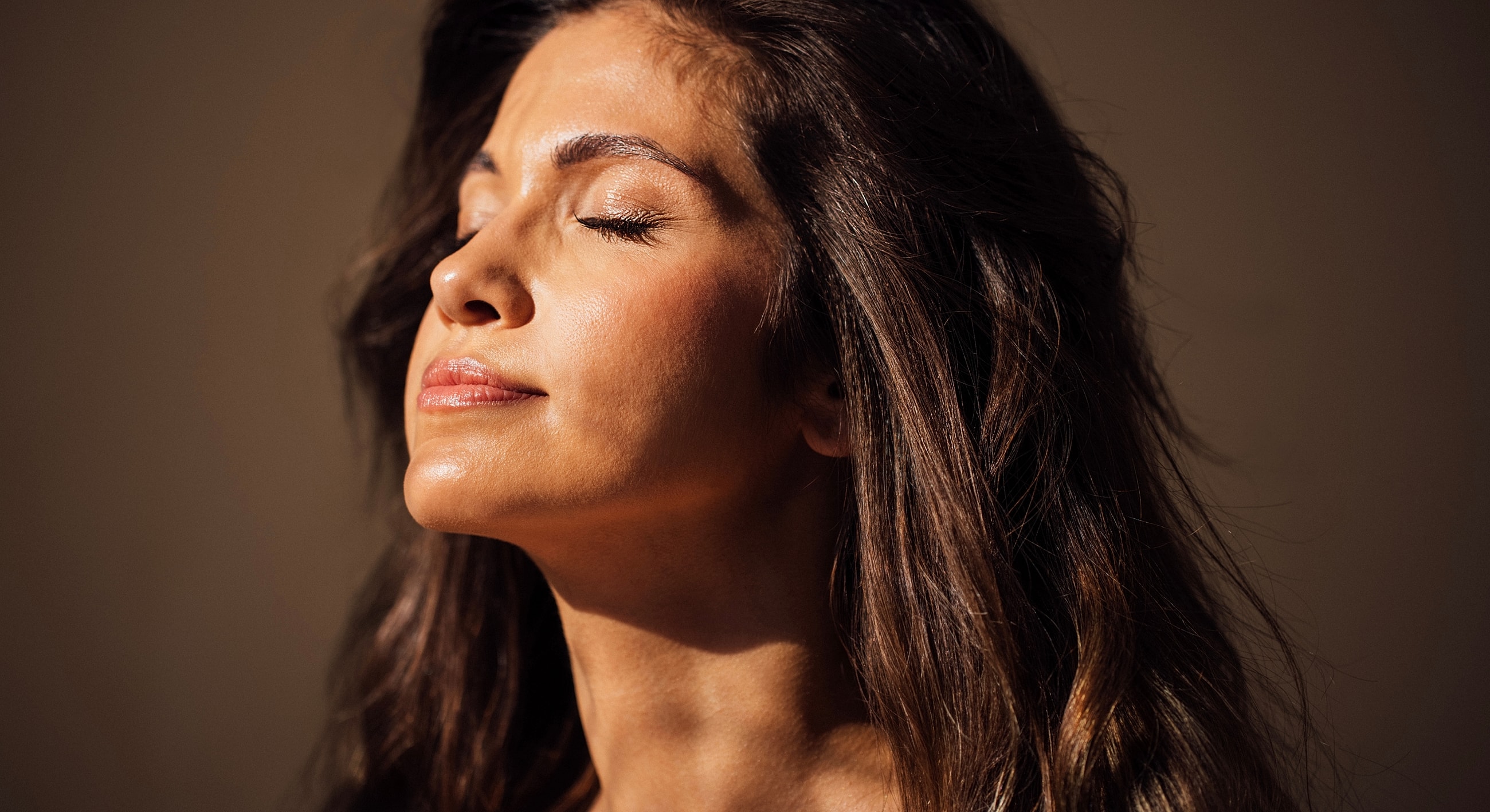 Woman enjoying a moment of tranquility and sunlight.