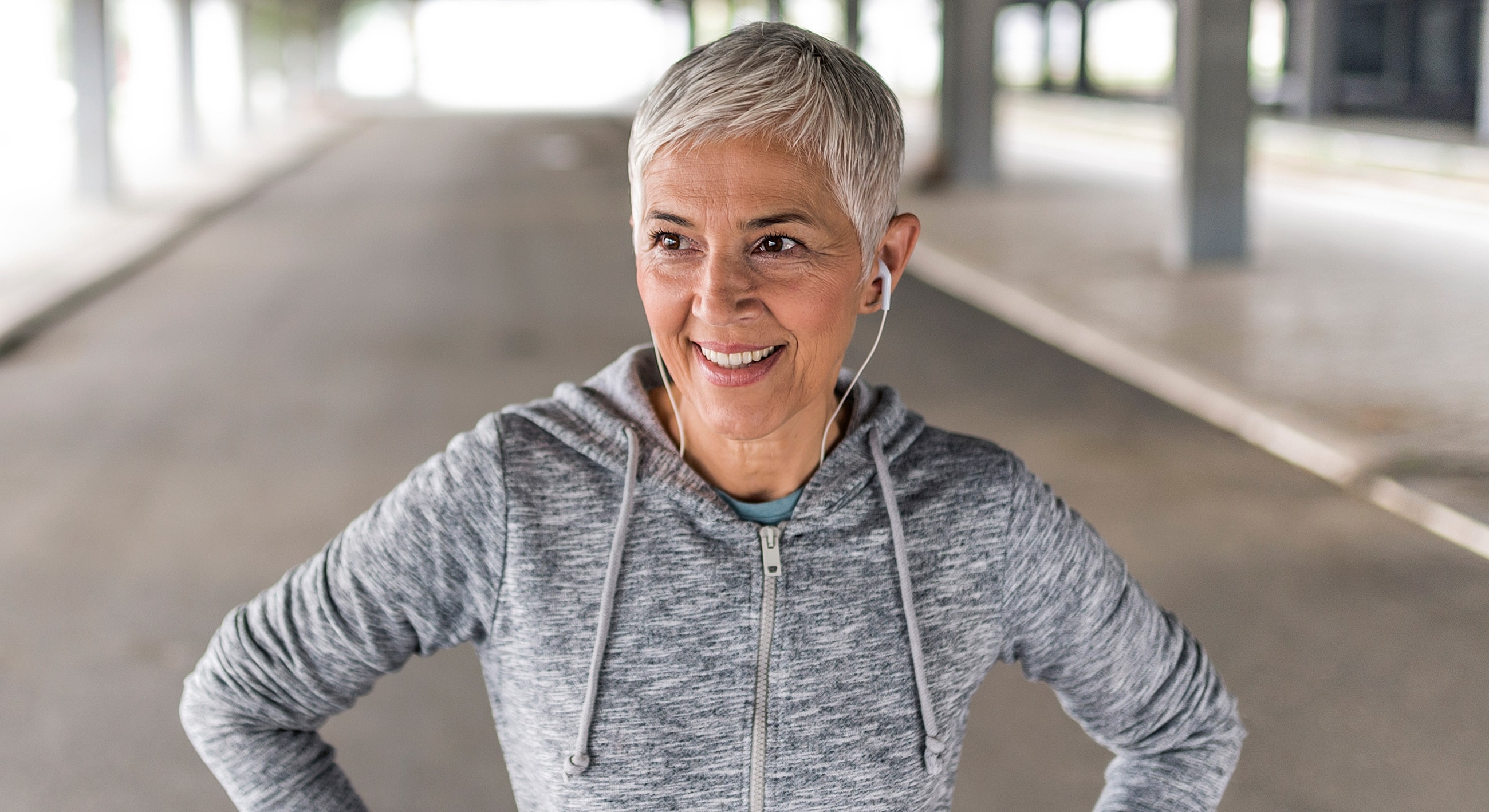 Roswell Wellness Tests model in workout attire with headphones.